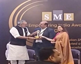 Dattatreya Lakshmi Narasimha receiving the SME Empowering India Award on stage.