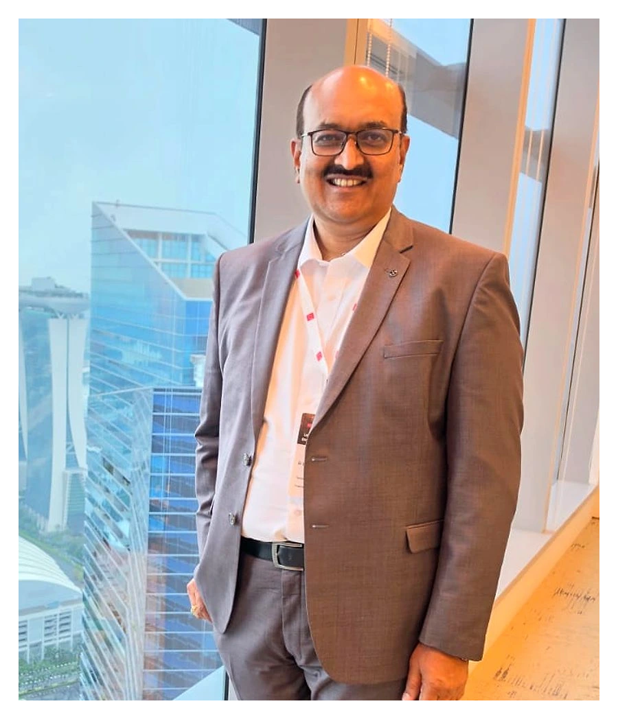 Dattatreya Lakshmi Narasimha (DLN), Chairman & Managing Director of Technogreen, at a window overlooking the Singapore skyline.