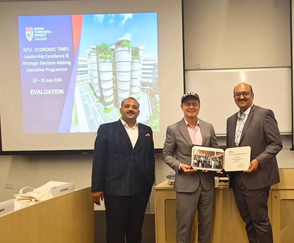 Dattatreya Lakshmi Narasimha receiving his certificate at Nanyang Technological University, Singapore, in front of a slide reading NTU — Economic Times Leadership Excellence and Strategic Decision-Making Executive Programme, 22 to 25 July 2026.