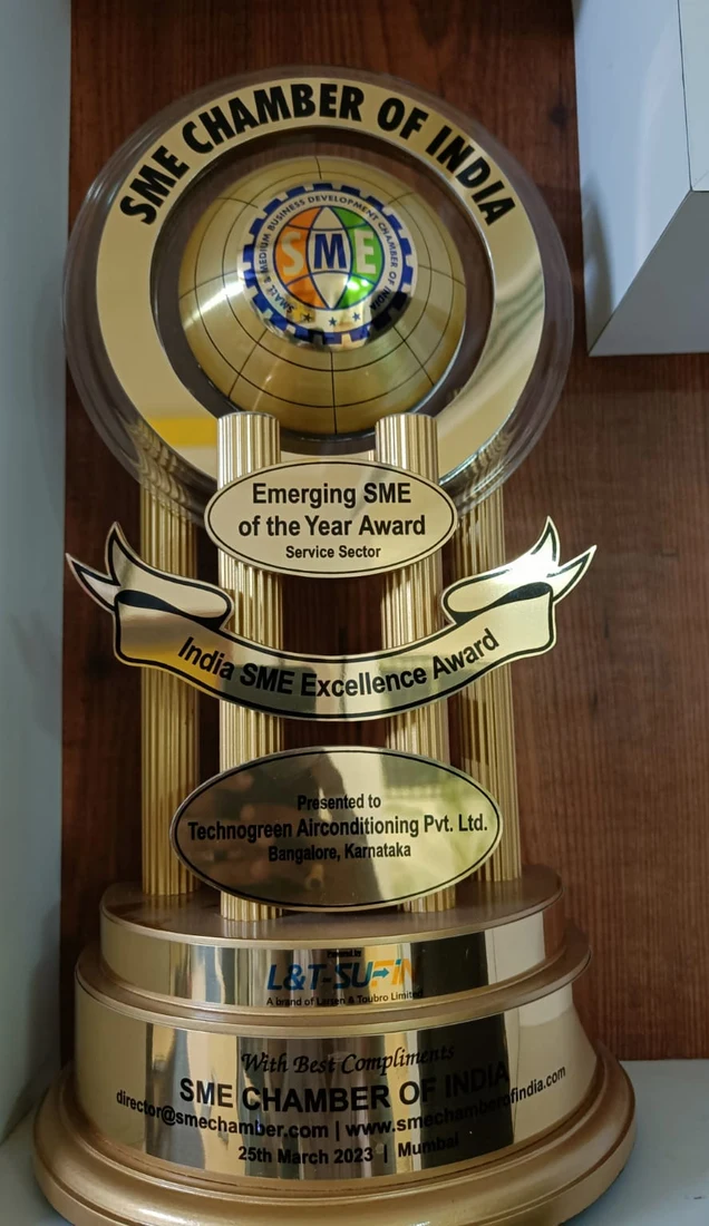 Gold trophy headed SME Chamber of India, with an oval plate reading Emerging SME of the Year Award, Service Sector, a banner reading India SME Excellence Award, and a base presented to Technogreen Airconditioning Pvt. Ltd., Bangalore, Karnataka, dated 25th March 2023, Mumbai.