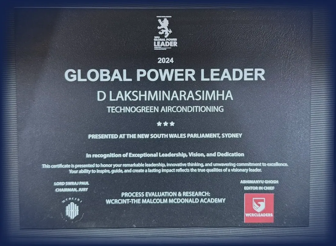 Dark stone plaque engraved 2024 Global Power Leader, D Lakshminarasimha, Technogreen Airconditioning, presented at the New South Wales Parliament, Sydney, in recognition of exceptional leadership, vision and dedication.