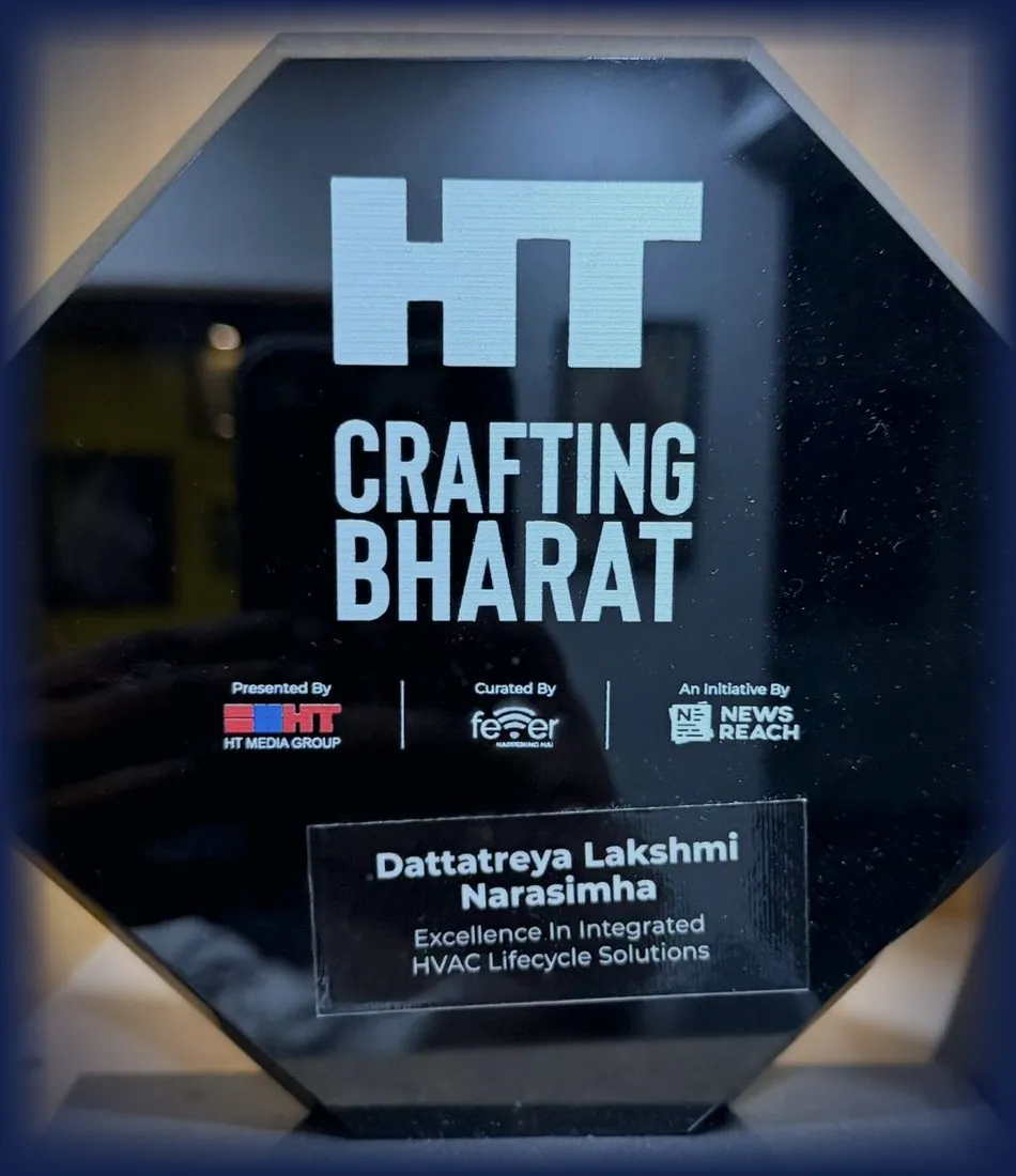 Black octagonal plaque reading HT Crafting Bharat, presented by HT Media Group, curated by Fever, an initiative by News Reach, with an inset plate naming Dattatreya Lakshmi Narasimha for Excellence In Integrated HVAC Lifecycle Solutions.