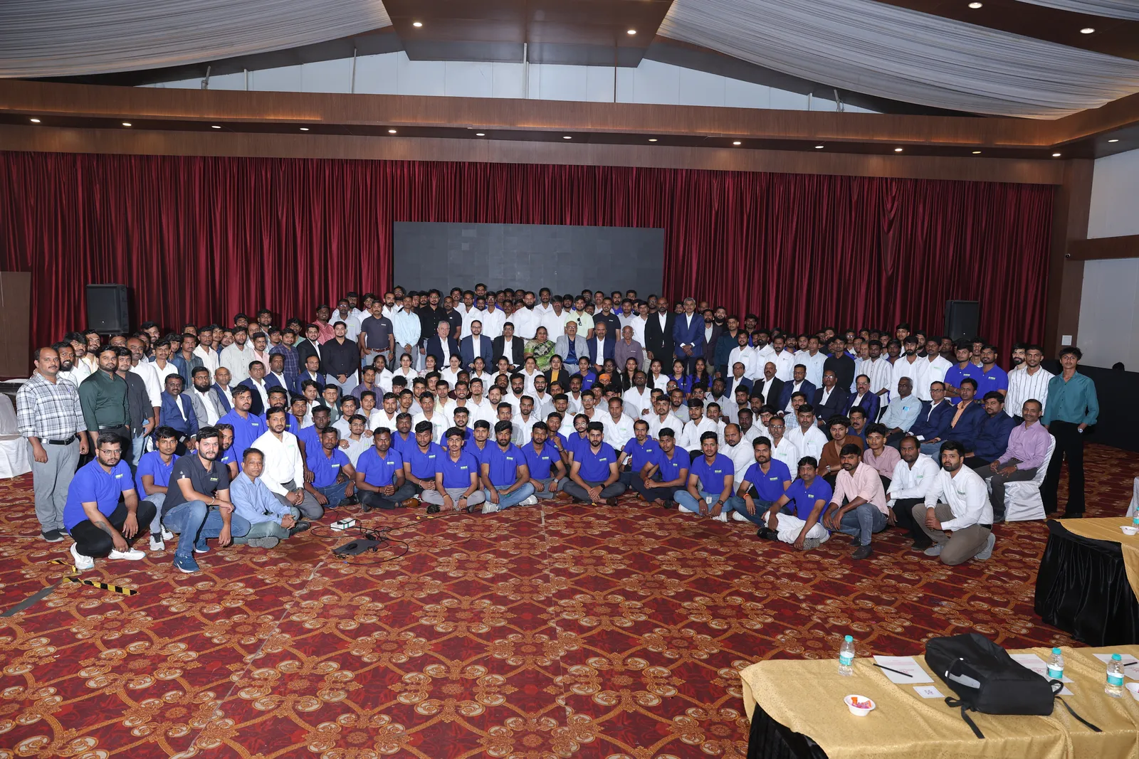 The whole company gathered for one group photograph in the banquet hall.