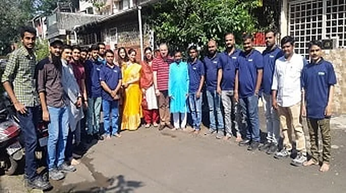 The team standing together for a group photograph outside the office.