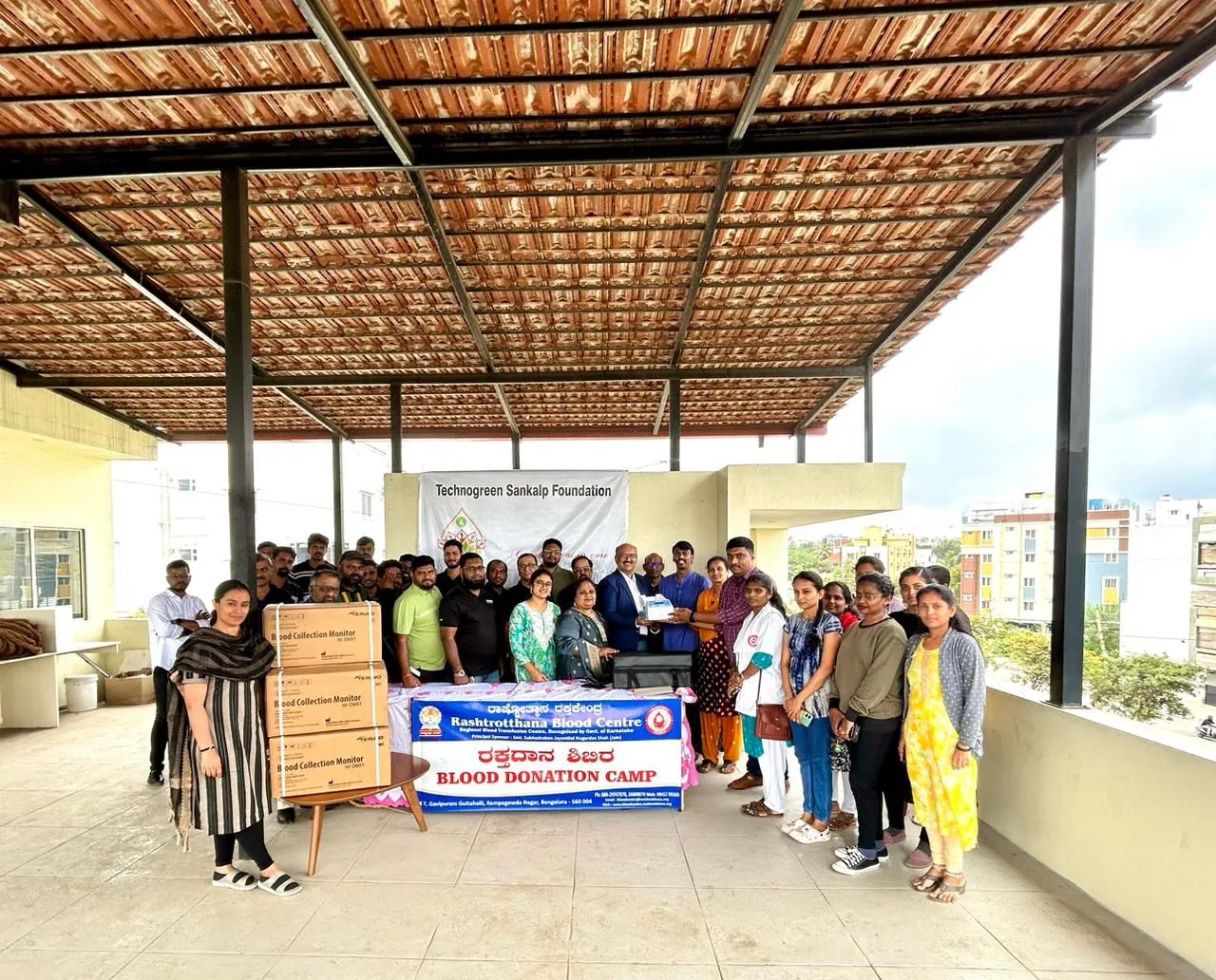 Everyone who turned out for the blood donation camp, gathered under the shelter behind the camp banner.