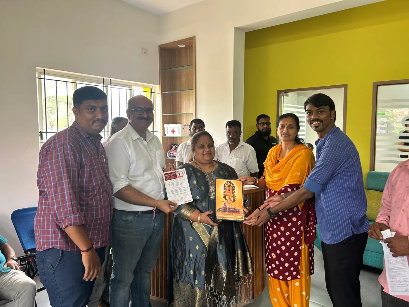 A handover at the blood centre, with the team and the centre's staff either side.