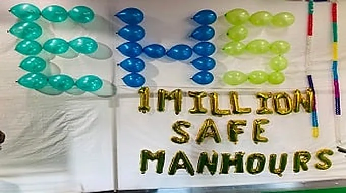 Gold and blue balloon letters spelling one million safe man hours.