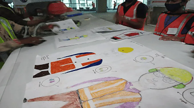 Children's drawings laid out on a table at a family art competition.